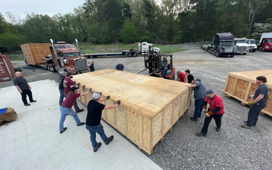 The Amada 9K Fiber Laser Being Unloaded in crates from the tractor trailers.