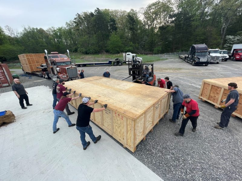 The Amada 9K Fiber Laser Being Unloaded in crates from the tractor trailers.